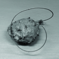 Earmuff, 2019, Graphite Powder on Useless Earmuff; 15x15x15 cm