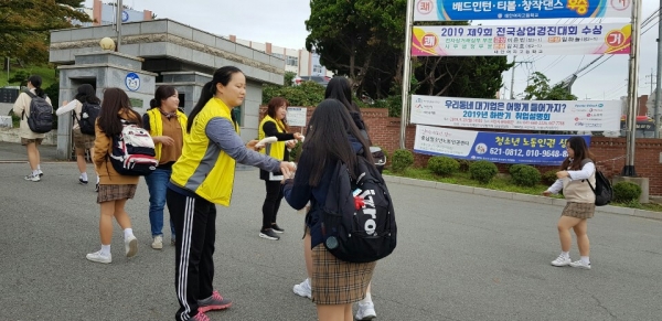 지난 10일 태안여자고등학교 학부모회(회장 송옥자)가 태안여고 정문에서 등교하는 학생 500여 명에게 가래떡을 나눠주는 모습.