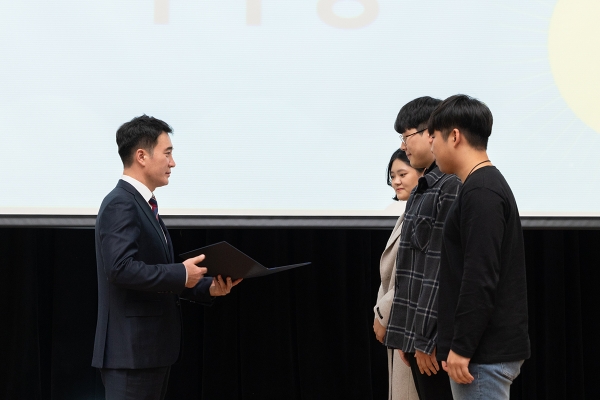 조한진 한국콘텐츠학회 부회장(왼쪽)이 목원대 융합컴퓨터·미디어학부 학생들에게 상장을 전달하고 있다.