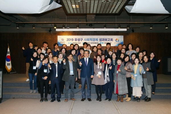 지난 18일 오후 라온컨벤션에서 정용래 유성구청장이 2019 유성구 사회적경제 성과보고회에 참석한 사회적경제기업 대표 및 종사자 등 60여 명과 함께 기념촬영