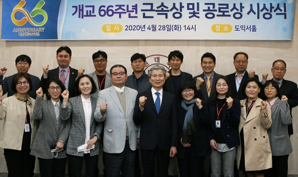 28일, 도익서홀에서 열린 ‘개교 66주년 기념 근속상 및 공로상 시상식’에서 직원 장기근속상 수상자들이 권혁대 총장과 함께 단체 기념촬영