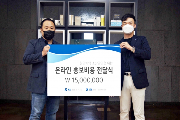 SL리테일 이상헌 사업총괄(오른쪽)과 SL네트웍스 정성운 사업총괄이 31일 본사 사무실에서 천안지역 소상공인을 위한 ‘온라인 홍보비용 전달식’을 갖고 기념사진을 촬영하고 있다.