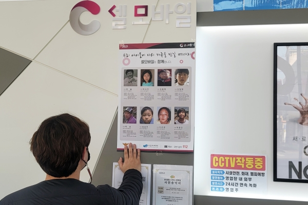 4일 천안 소재 셀모바일 휴대폰 매장에서 ‘2021 실종아동 찾기’ 캠페인을 위해 매장 직원이 포스터를 부착하고 있다.