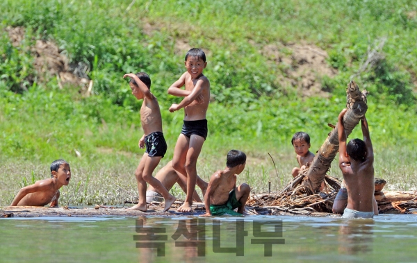 압록강 뗏목 위에서 물놀이를 즐기고 있는 북한 아이들 모습. (녹색나무 제공)