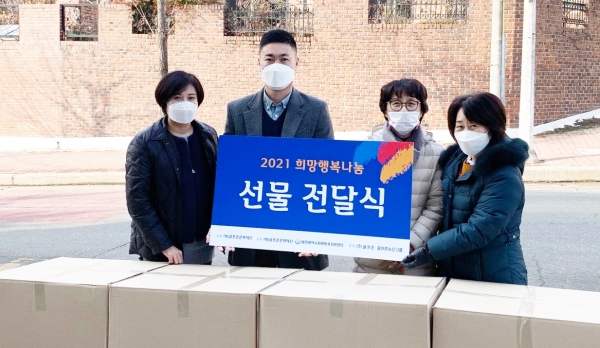 골프존문화재단이 충북 지역 아동센터 관계자들에게 아동용 선물 키트를 전달하고 있다