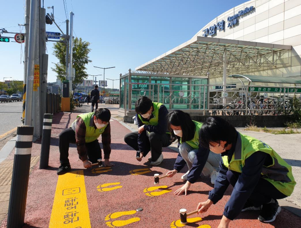 13일, 대전교통공사 직원들이 구암역 3번 출구 인근 횡단보도를 이용하는   시민들의 교통사고 예방을 위해 ‘노란 발자국’ 스티커를 부착하고 있다