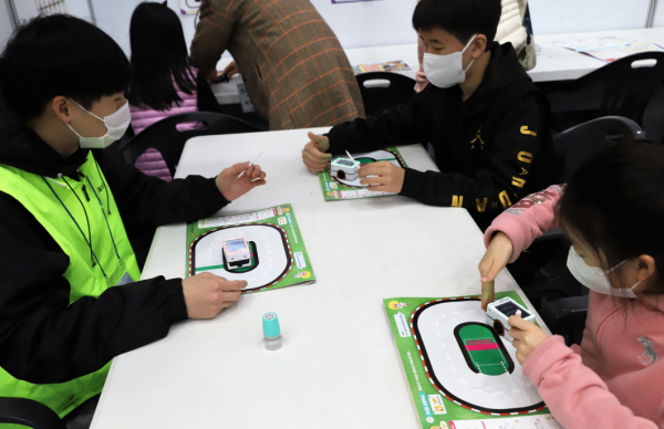 관람객이 체험부스에서 자율주행 로봇을 체험하고 있다.