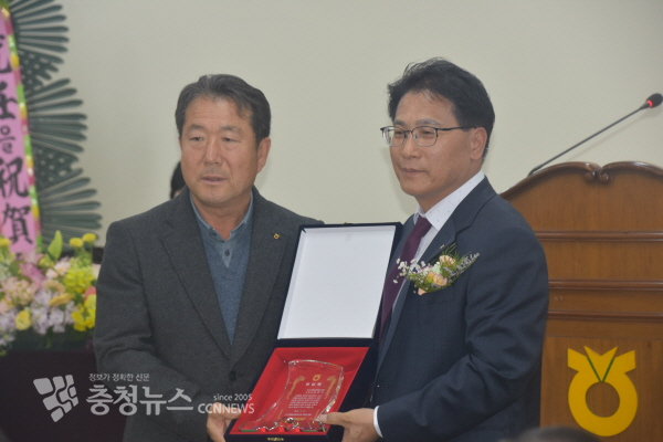 김용두 조합장이 이형재 조합원 대표로부터 취임패를 받고 있다.