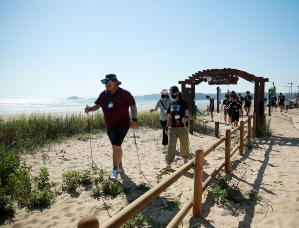 남면 몽산포 해변에서 노르딕 워킹 중인 지난해 태안 해양치유 시범 프로그램 참여자들 모습(22. 5. 27.)